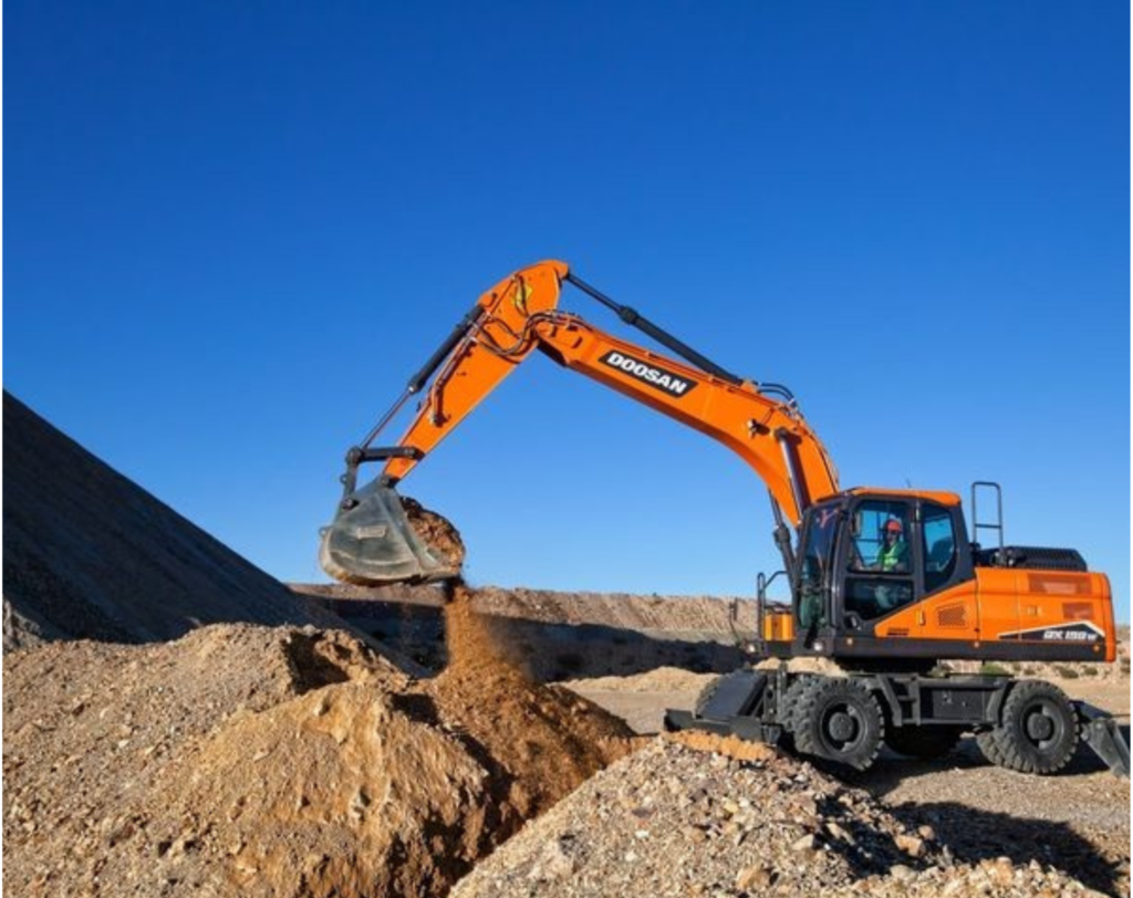 Orange Doosan excavator operated by JKT Outdoor Services Ltd. performing land excavation in Parkland County, Alberta, Canada.