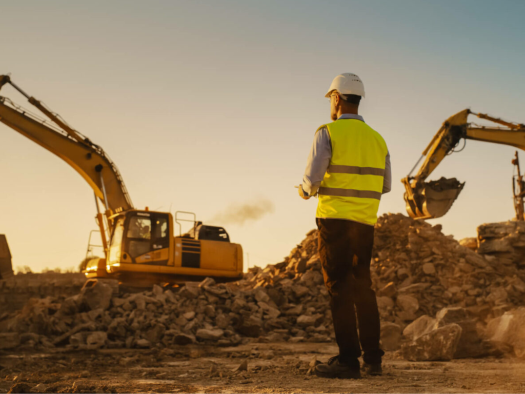 JKT Outdoor Services Ltd. supervisor overseeing excavation work with yellow excavators in Parkland County, Alberta, Canada.