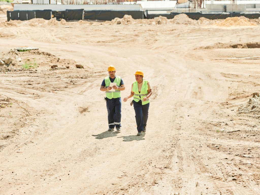 JKT Outdoor Services Ltd. team inspecting graded dirt road on a construction site in Parkland County, Alberta, Canada.