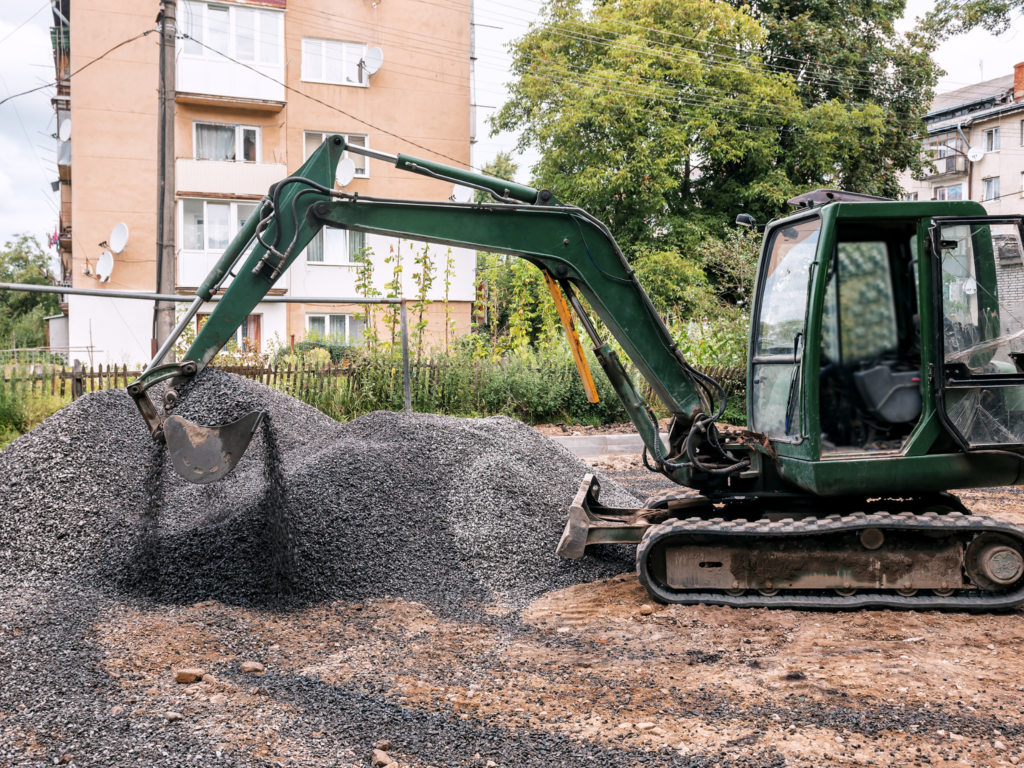 Excavator used by JKT Outdoor Services Ltd. for gravel pad installation in Parkland County, Alberta, Canada.