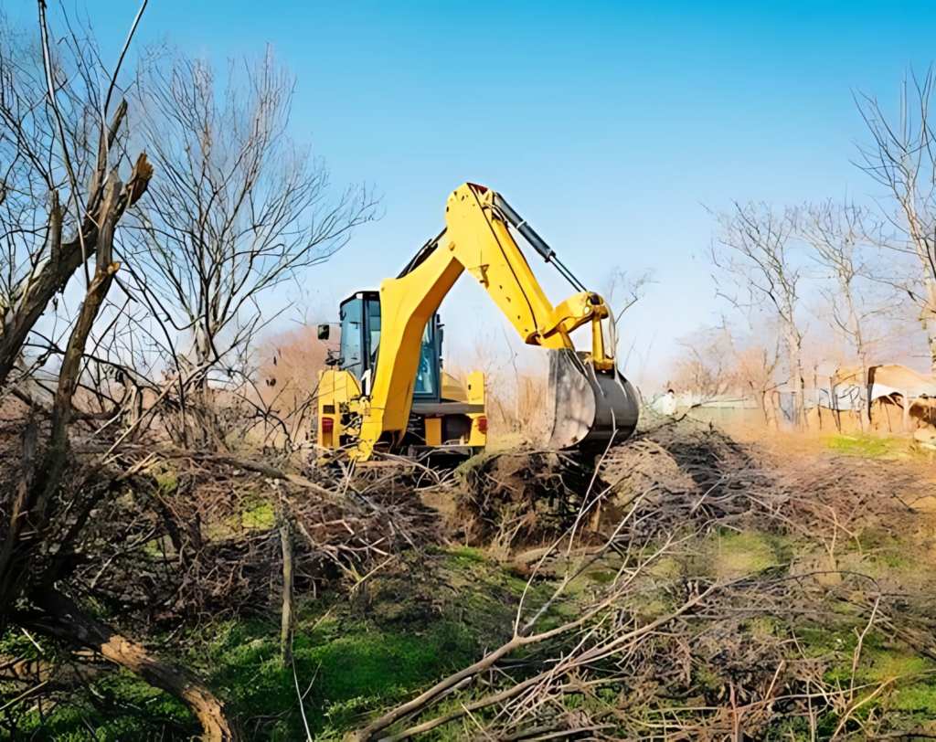 Excavator used by JKT Outdoor Services Ltd. clearing debris for land clearing in Parkland County, Alberta, Canada.