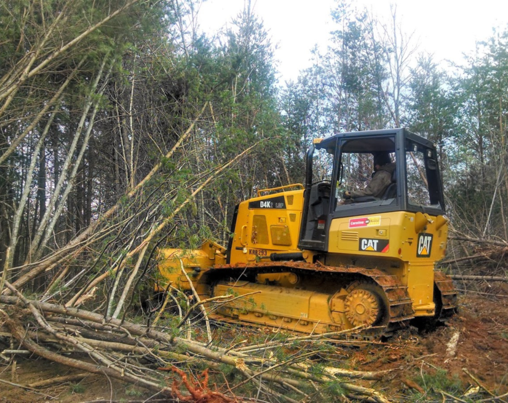 JKT Outdoor Services Ltd. team operating a skid steer for land clearing in Parkland County, Alberta, Canada.